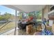 Enclosed porch with screens offering views of the backyard and greenery, plus ample room for storage at 3197 Normandy Dr, Port Charlotte, FL 33952
