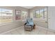 A cozy sunroom featuring large windows, a comfortable chair, and tile flooring, perfect for relaxation at 3197 Normandy Dr, Port Charlotte, FL 33952