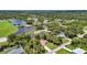 Neighborhood aerial view, showcasing community lake, mature trees, and homes in a serene setting at 3305 Nansen Ln, North Port, FL 34286
