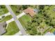 Beautiful aerial view of home with a backyard pool, mature trees, and long driveway at 3305 Nansen Ln, North Port, FL 34286