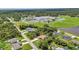 Community aerial view of home, close to neighborhood park and lake with mature trees surrounding at 3305 Nansen Ln, North Port, FL 34286