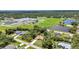 Community aerial view, with neighborhood park, play area, lake and mature trees surrounding home at 3305 Nansen Ln, North Port, FL 34286