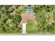 Aerial view of home showcasing backyard pool, mature trees, green space and large driveway at 3305 Nansen Ln, North Port, FL 34286