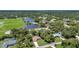 Scenic aerial view of home, community lake, park, and mature trees, in a quiet neighborhood at 3305 Nansen Ln, North Port, FL 34286