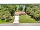 Beautiful aerial view of home, showcasing the mature trees, manicured lawn and neighborhood lake at 3305 Nansen Ln, North Port, FL 34286