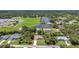 Aerial view of community, showcasing the nearby park, play area, lake and mature trees surrounding the home at 3305 Nansen Ln, North Port, FL 34286