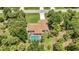 Overhead view of a private residence featuring a screened pool, mature trees, and well-maintained landscaping at 3305 Nansen Ln, North Port, FL 34286