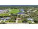 Aerial view of property highlighting proximity to a school, park, and pond at 3305 Nansen Ln, North Port, FL 34286