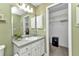Well-lit bathroom featuring a spacious vanity, a safe, and convenient storage options at 3305 Nansen Ln, North Port, FL 34286