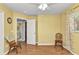 Bright bedroom features hardwood floors, ceiling fan, natural light, and ensuite bathroom access at 3305 Nansen Ln, North Port, FL 34286