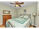 Inviting bedroom showcasing a cozy bed with wrought iron frame, and dresser at 3305 Nansen Ln, North Port, FL 34286