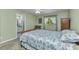Bedroom features carpeted floors, a ceiling fan, a window, and an ensuite bathroom at 3305 Nansen Ln, North Port, FL 34286
