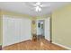 Bright bedroom features hardwood floors, ceiling fan, spacious closet, and ensuite bathroom access at 3305 Nansen Ln, North Port, FL 34286