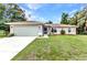 Well-maintained single-Gathering home with a manicured lawn, two-car garage, and inviting curb appeal at 3305 Nansen Ln, North Port, FL 34286