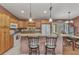 Well-appointed kitchen featuring granite countertops, wood cabinets, and a breakfast bar for casual dining at 3305 Nansen Ln, North Port, FL 34286