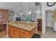 Open concept kitchen featuring granite countertop island with seating and views into the living room at 3305 Nansen Ln, North Port, FL 34286