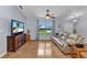 Living room featuring hardwood floors, a large window and a leather sofa at 3305 Nansen Ln, North Port, FL 34286