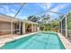 Sparkling screened-in pool featuring inviting outdoor relaxation and covered patio with ceiling fan at 3305 Nansen Ln, North Port, FL 34286