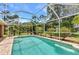 Relaxing screened-in pool area with lush landscaping and lots of space for entertaining at 3305 Nansen Ln, North Port, FL 34286