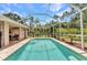 Refreshing screened-in pool offering a private oasis with lush greenery and comfortable seating at 3305 Nansen Ln, North Port, FL 34286