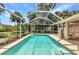 Sparkling screened-in pool surrounded by lush landscaping offers the ultimate private backyard oasis at 3305 Nansen Ln, North Port, FL 34286