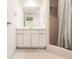 Bright bathroom featuring a vanity with ample storage and a shower with neutral tile and striped curtain at 3497 Cohoes St, Port Charlotte, FL 33952