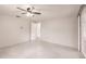This bedroom features a ceiling fan, an open doorway, and terrazzo floors at 3497 Cohoes St, Port Charlotte, FL 33952