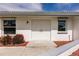Close up on the double door entrance with a concrete walk and manicured shrubs at 3497 Cohoes St, Port Charlotte, FL 33952