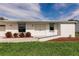 Home featuring a clean white exterior, concrete walkway, and tidy landscaping at 3497 Cohoes St, Port Charlotte, FL 33952