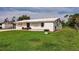 Inviting single-story home with a well-maintained lawn and bright white exterior at 3497 Cohoes St, Port Charlotte, FL 33952
