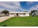 Charming single-story home featuring a well-manicured lawn and a bright white exterior at 3497 Cohoes St, Port Charlotte, FL 33952