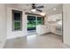 Well-lit kitchen featuring bright white cabinets, appliances and a view to the backyard at 3497 Cohoes St, Port Charlotte, FL 33952