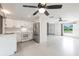 Bright kitchen features white cabinets, stainless steel appliances, and a ceiling fan at 3497 Cohoes St, Port Charlotte, FL 33952