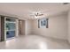Bright living room features terrazzo flooring, large windows, and a ceiling fan at 3497 Cohoes St, Port Charlotte, FL 33952