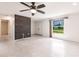 Bright living room with stylish ceiling fan, brick wall, and a large, bright window at 3497 Cohoes St, Port Charlotte, FL 33952