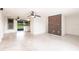 Open-concept living room with ceiling fans, brick accent wall, and polished floors at 3497 Cohoes St, Port Charlotte, FL 33952