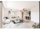 Open-concept living room featuring a large sectional sofa, modern decor, and seamless flow into the dining area at 3497 Cohoes St, Port Charlotte, FL 33952