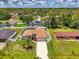 Expansive aerial view of the property showcases lush landscaping, fenced yard, sparkling pool, and well-maintained exterior at 4038 Corydon Ave, North Port, FL 34286