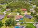 Aerial view of a property with a screened pool, fire pit, and fenced yard in a residential area at 4038 Corydon Ave, North Port, FL 34286