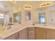 Bright bathroom features double sinks, large mirrors, and ample counter space at 4038 Corydon Ave, North Port, FL 34286