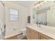 Bathroom showcasing a large mirror, spacious vanity, and a shower and tub combination at 4038 Corydon Ave, North Port, FL 34286