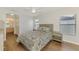 Cozy bedroom features a ceiling fan, wood flooring, and bright natural lighting at 4038 Corydon Ave, North Port, FL 34286