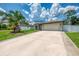 The exterior view showcases the front of the home with a 2-car garage, arched entryway, and well-maintained landscaping at 4038 Corydon Ave, North Port, FL 34286