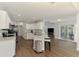 Bright kitchen with white cabinets, granite countertops, and an adjacent living area, perfect for entertaining at 4038 Corydon Ave, North Port, FL 34286