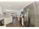 Open-concept kitchen with stainless steel appliances, granite countertops, and seamless connection to the dining area at 4038 Corydon Ave, North Port, FL 34286
