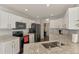 Kitchen with stylish countertops, modern appliances, and easy access to other living spaces at 4038 Corydon Ave, North Port, FL 34286