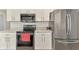 Kitchen featuring modern appliances, white cabinetry, and ample countertop space for meal preparation at 4038 Corydon Ave, North Port, FL 34286