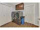 Clean and modern laundry room with wood floors, overhead cabinets, and washer and dryer at 4038 Corydon Ave, North Port, FL 34286