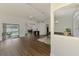 Spacious living room boasts an open layout, wood floors, and seamless access to the screened pool area with a patio at 4038 Corydon Ave, North Port, FL 34286