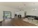 Bright living room features wood floors, an open layout, and direct access to the screened pool area with patio at 4038 Corydon Ave, North Port, FL 34286